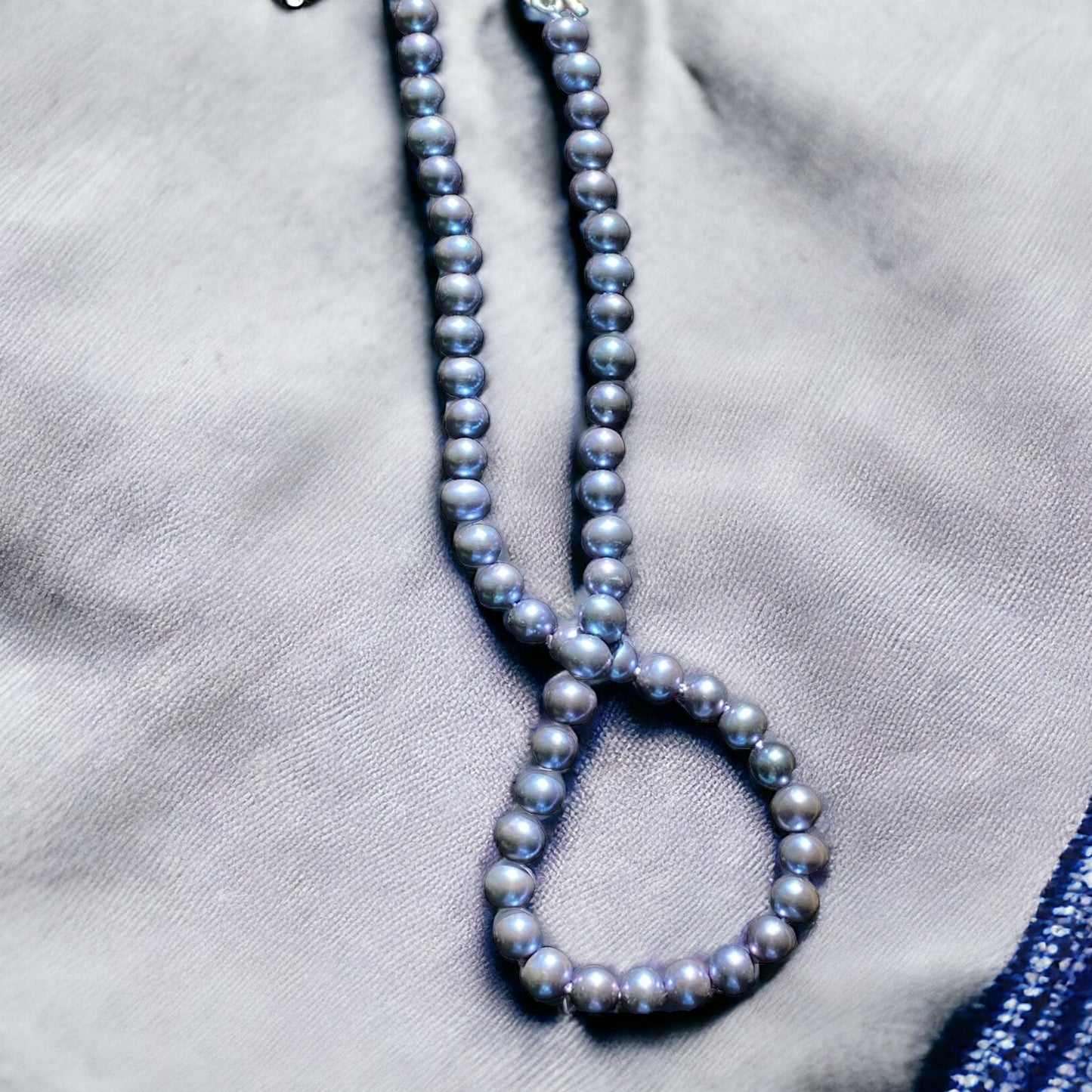 Lavender blue pearls on matching color silk,hand knotted with sterling silver handmade adjustable clasp 16-18” total length.